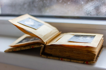 Old paper photo album with black and white photo
