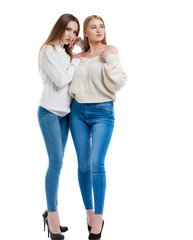 Two women in blue jeans and white sweater