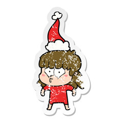 distressed sticker cartoon of a whistling girl wearing santa hat
