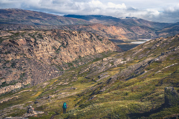 Hiking in the Arctic Circle Trail (ACT) down to a valley with a river crossing, Greenland © Tomas Zavadil