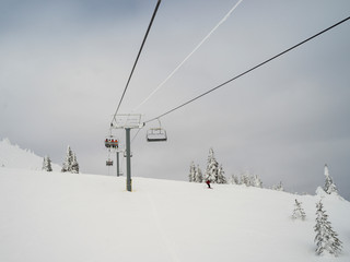 Fototapeta na wymiar Overhead cable cars over a hill, Sun Peaks Resort, Sun Peaks, British Columbia, Canada