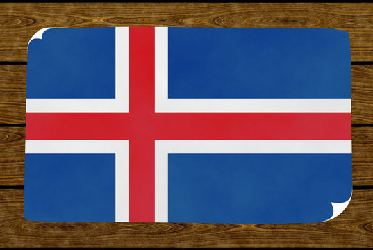 Graphic illustration of an Icelandic flag painted on the paper pasted on the woody wall