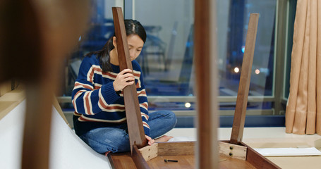Asian Woman assemble the table at home