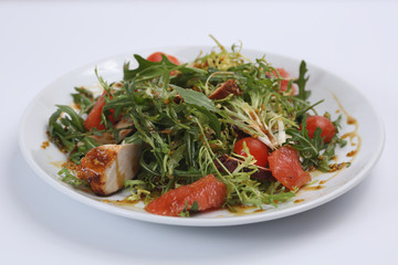 restaurant dish, green salad, cucumbers, red pepper, boiled meat, arugula, tomato and grapefruit, healthy food, close-up, for the menu