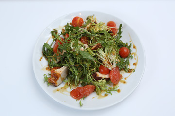 restaurant dish, green salad, cucumbers, red pepper, boiled meat, arugula, tomato and grapefruit, healthy food, close-up, for the menu