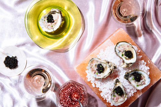 caviar on on the half shell with rose on pink velvet