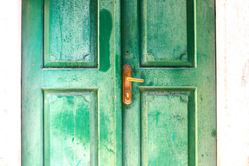 Authentic house with a stone wall and a beautiful door and flowerpots with flowers at the entrance, in minimal style, bright colors, background. Montenegro