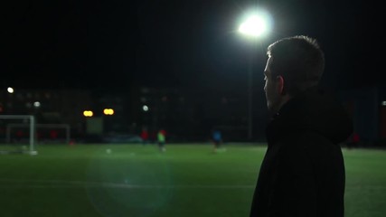 The guy looks at the training of football players