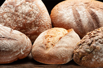 Bread arranged on wooden table .