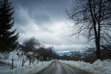 Winter road in winter mountain scene with snow, trees, winter resort Smolyan, Bulgaria, Rhodope Mountains. Road in mountain valley, winter fairy tale