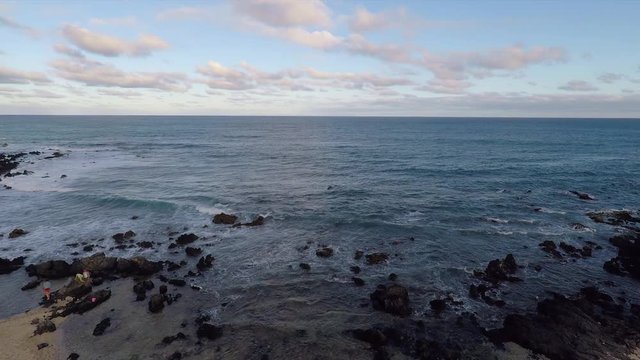 Drone flies out to sea near Sandy Beach in Oahu, Hawaii.