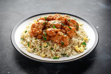 Orange Chicken Spicy sweet and sour with fried eggs rice in a plate