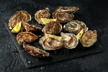Fresh Oysters platter with lemon and ice. ready to open and eat