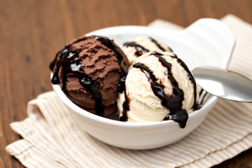 Bowl with tasty ice cream on table