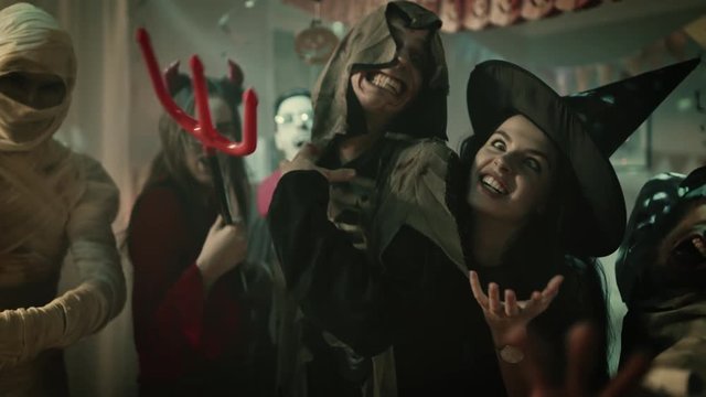 Halloween Costume Party: Brain Dead Zombie, Blood Thirsty Dracula, Bandaged Mummy Beautiful Witch and Seductive She Devil Suddenly Turn around and Start Making Scary Faces