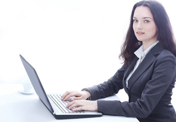 side view.business woman typing on a laptop.