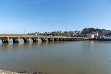 Fototapeta na wymiar Bideford, North Devon, England UK. March 2019. Looking from Bideford town over the Bideford Long bridge built in 1850 to East The Water.