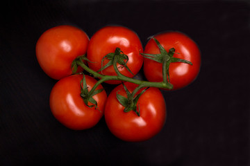 tomatoes on black background