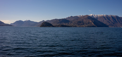 Italy, Menaggio, Lake Como, a large body of water with a mountain in the background