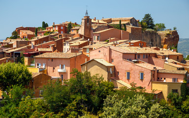 Fototapeta na wymiar Panoramic view of hilltop medieval ochre village of Roussillon one of the most beautiful villages of France in a sunny summer day. Provence, travel France.