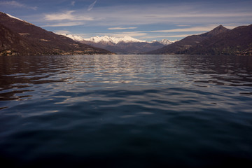 Fototapeta na wymiar Italy, Menaggio, Lake Como, a body of water with a mountain in the background