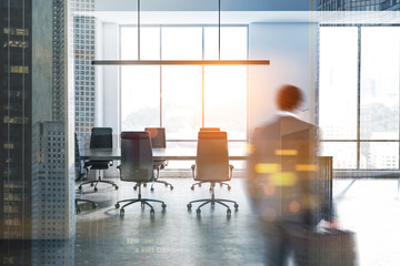 Man in white and concrete meeting room interior