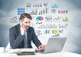 Man with laptop at table, graphs and infographics