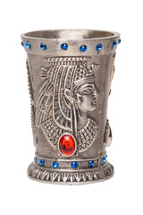 Egyptian art. Close-up of egyptian metalic cup with gems isolated on a white background. Egypt souvenir. Macro.