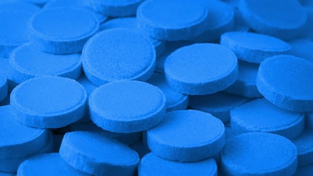 Pile Of Blue Medical Tablets Rotating
