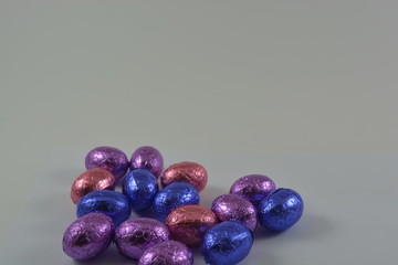 chocolate easter eggs in a glass basket on a white background