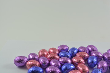 chocolate easter eggs in a glass basket on a white background