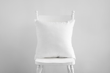 Mockup of white square cushion on white wooden vintage dining chair.