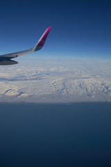 Fototapeta premium Aerial View of Iceland Coastline with Wing of Plane in Flight