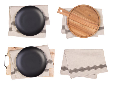 Black Plates, Cutting Board And Tea Towels Isolated On White Background, Top View	