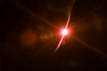 Fototapeta na wymiar abstract lens flare red light over black background