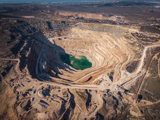Open cast quarry for digging and production of flux limestone, gravel material, crushed stone and sand, aerial view. Mining  industry