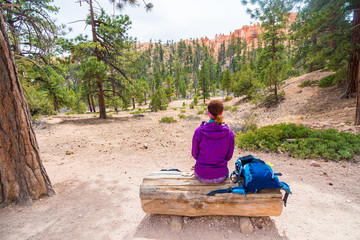 Woman in Bryce Canyon looking and enjoying view during her hike. Bryce Canyon National Park landscape, Utah, United States.