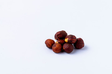 Heap of hazelnuts on white background.