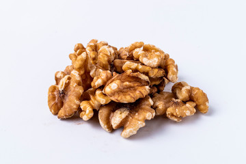 Peeled walnuts on white background.