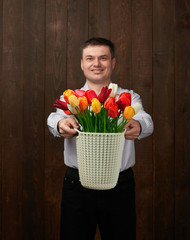 Man holds a basket with flowers