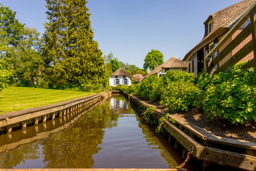 Fototapeta na wymiar Netherlands, Giethoorn, a canal in front of a house