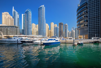 Fototapeta na wymiar Dubai marina with luxury yachts and skyscrapers at the sunset, Dubai, United Arab Emirates