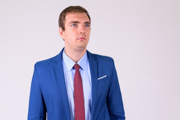 Portrait of businessman in suit thinking and looking up