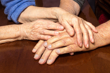 Old people holding hands. Closeup.
