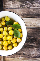 Yellow plums. Fresh ripe sweet fruits on old wooden boards rough background