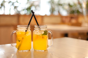 two glasses of orange juice on a table in a rastaurant