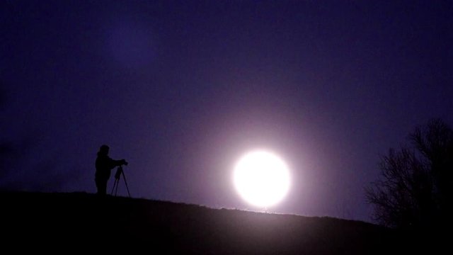 Photographer and the rising of the Moon
