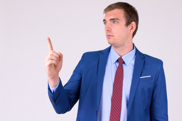 Portrait of businessman in suit thinking and pointing up