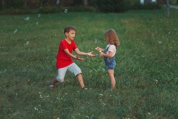 children playing with soap bubbles in park