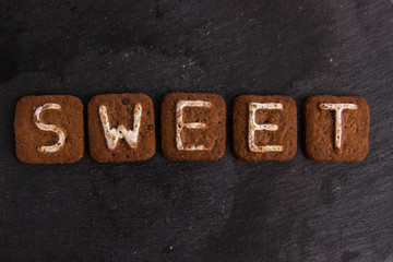 The word SWEET laid out with cookies letters